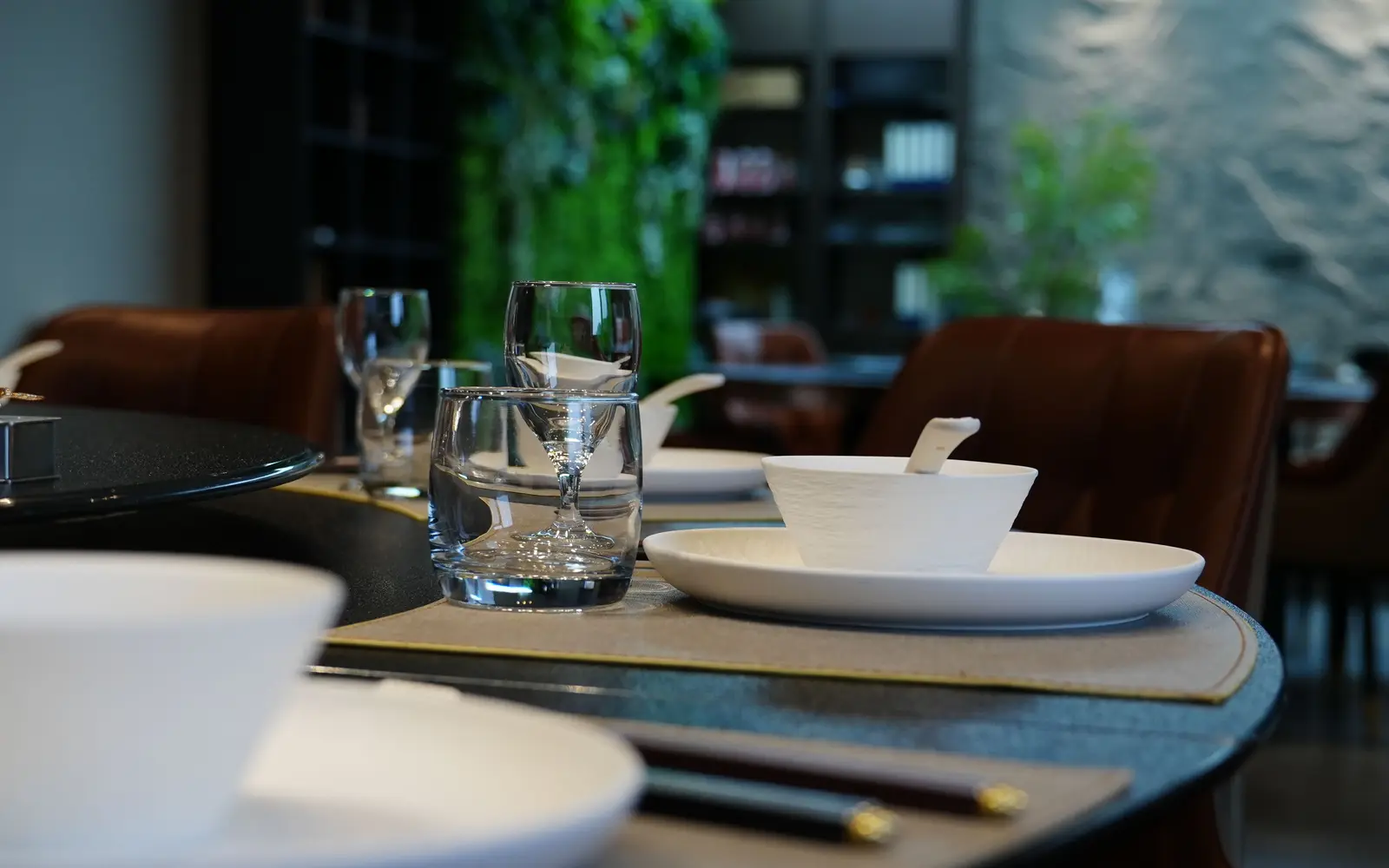 Long table set for a private dining event with glassware and tableware
